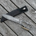 12 inch Death's Head fighter. 1/4 inch 01 tool steel antiqued. 7 inch blade supplied with leather sheath. RIP201